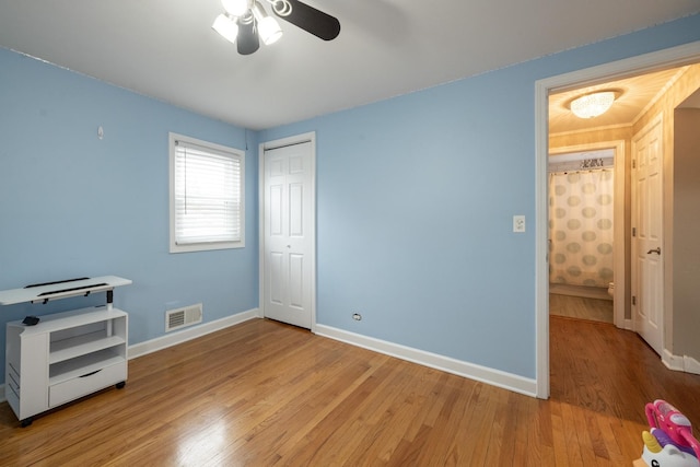 bedroom featuring a closet, ceiling fan, and light hardwood / wood-style flooring