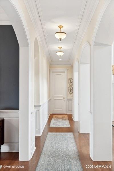 hallway featuring hardwood / wood-style floors and crown molding