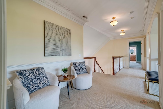 sitting room featuring crown molding and light colored carpet