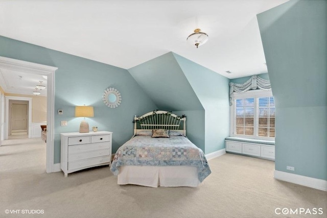 bedroom with lofted ceiling and light carpet