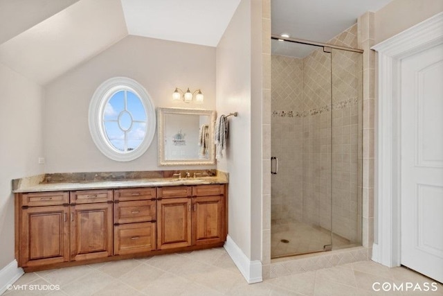 bathroom with tile patterned floors, vanity, an enclosed shower, and lofted ceiling