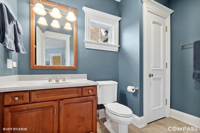 bathroom with vanity, toilet, and tile patterned flooring