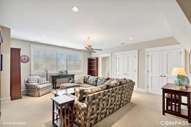 living room featuring light carpet and ceiling fan