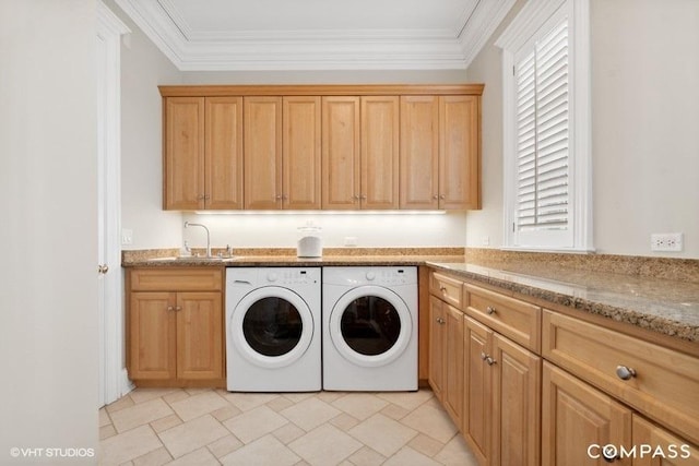 laundry area featuring sink, crown molding, cabinets, a wealth of natural light, and washing machine and clothes dryer