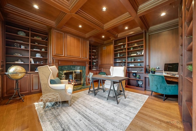 sitting room with coffered ceiling, crown molding, a fireplace, and wooden ceiling