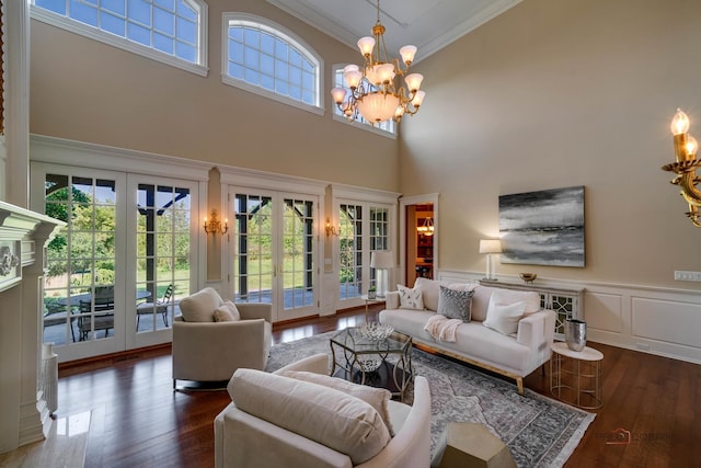 living room featuring french doors, ornamental molding, dark hardwood / wood-style floors, and a wealth of natural light