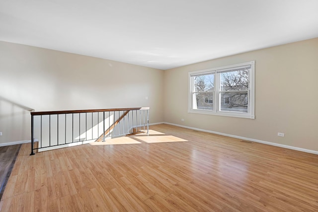 spare room with light wood-type flooring