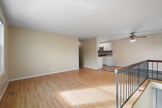 interior space featuring ceiling fan and light wood-type flooring