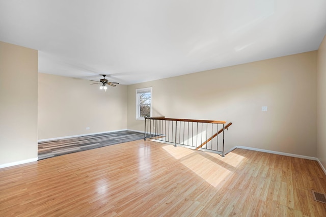 spare room featuring ceiling fan and light wood-type flooring