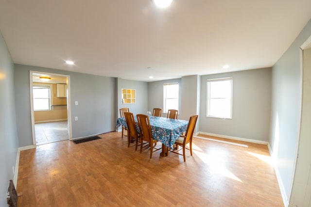 dining space with light hardwood / wood-style flooring