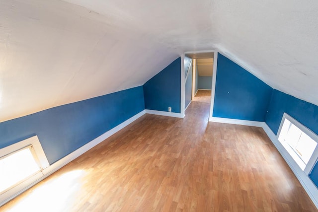 bonus room featuring lofted ceiling and wood-type flooring