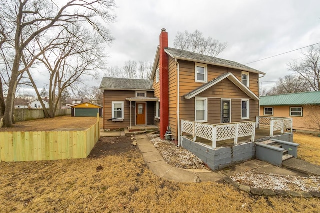 rear view of house with an outbuilding and a garage