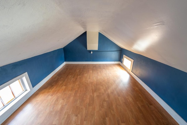 bonus room featuring lofted ceiling and wood-type flooring