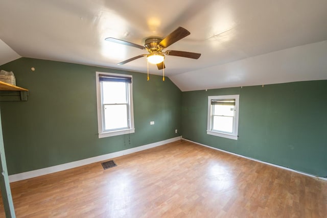 bonus room featuring vaulted ceiling, a wealth of natural light, and light hardwood / wood-style flooring