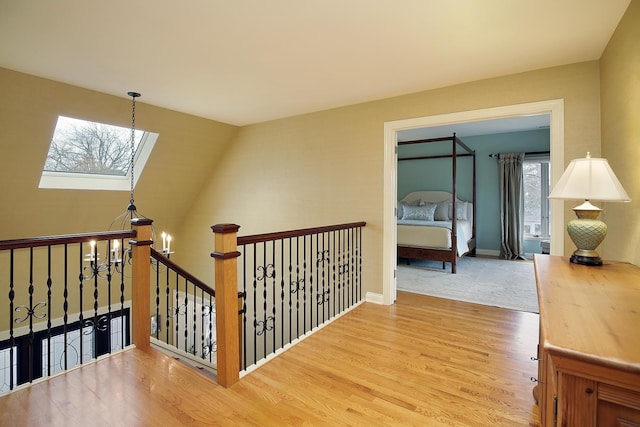 hall featuring a notable chandelier and wood-type flooring