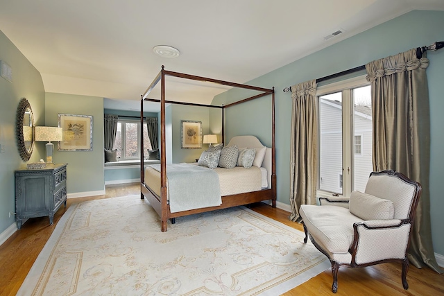 bedroom featuring vaulted ceiling and light hardwood / wood-style flooring