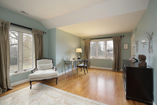 sitting room featuring lofted ceiling and light hardwood / wood-style floors