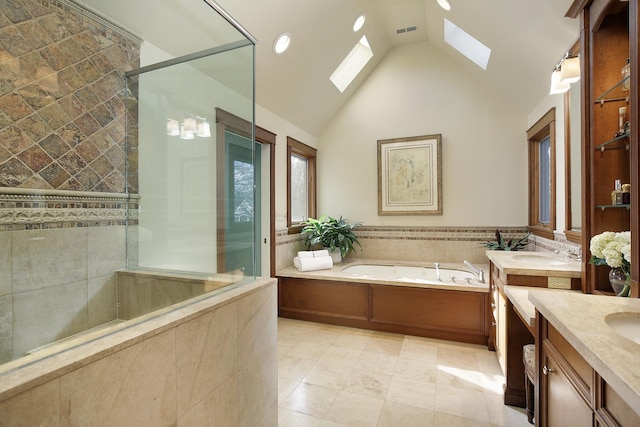 bathroom with shower with separate bathtub, vanity, high vaulted ceiling, and a skylight