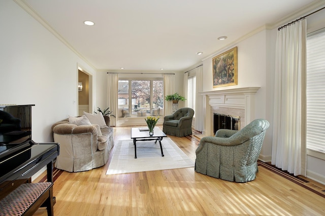 living room featuring crown molding and light hardwood / wood-style flooring