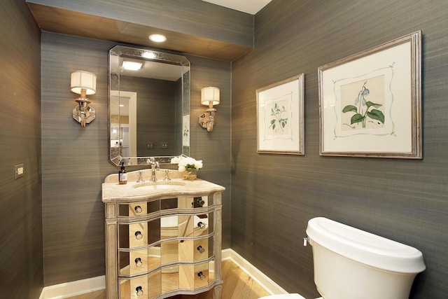 bathroom with vanity, hardwood / wood-style floors, and toilet