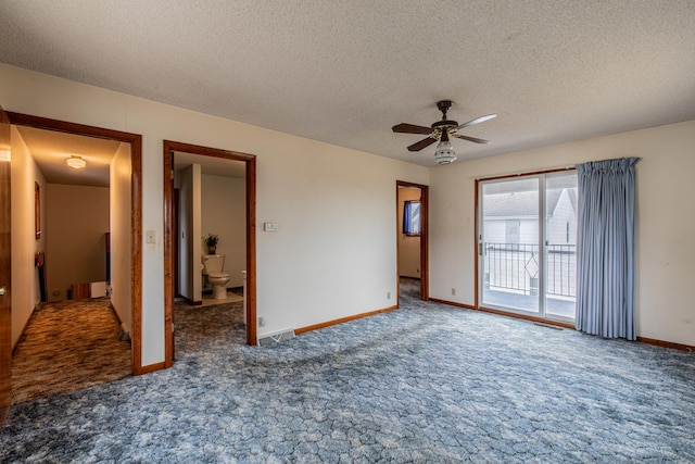 spare room featuring ceiling fan, a textured ceiling, and dark colored carpet