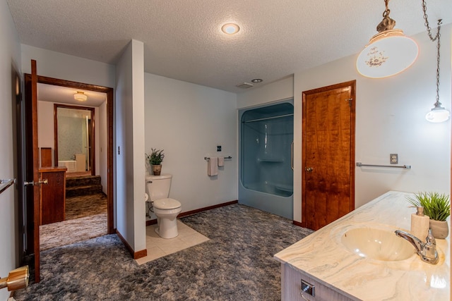 bathroom featuring vanity, a textured ceiling, and toilet