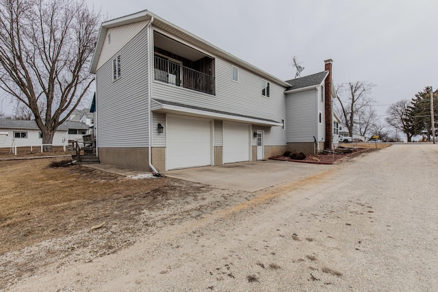 rear view of house with a garage