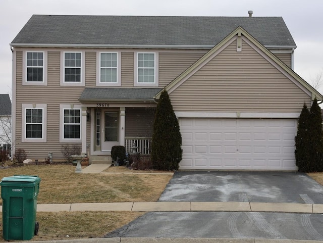 view of front of house with a garage and a front yard