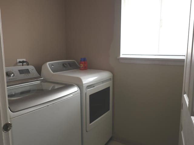 clothes washing area featuring washer and clothes dryer