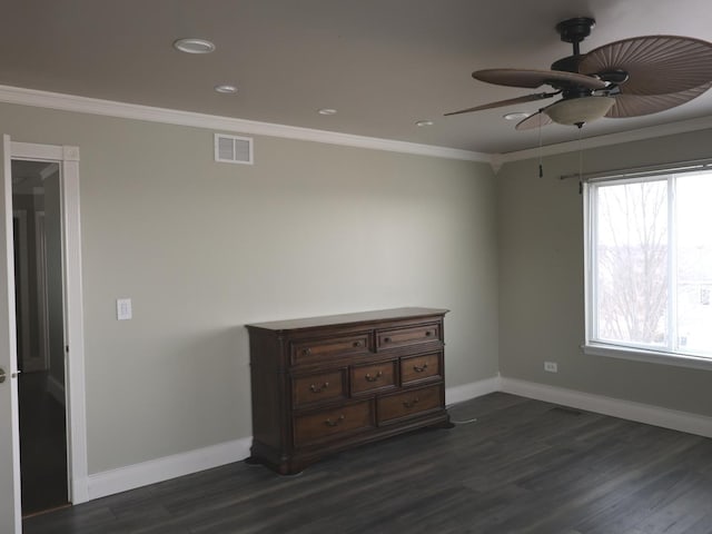 spare room with crown molding, ceiling fan, and dark hardwood / wood-style flooring