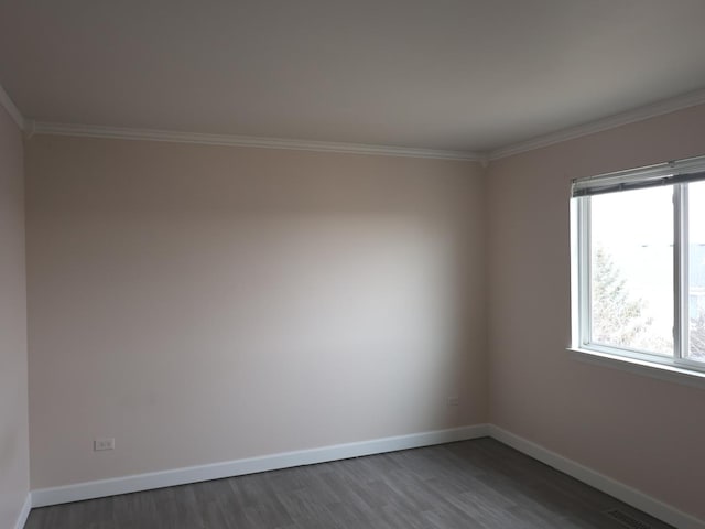 empty room with dark wood-type flooring and ornamental molding