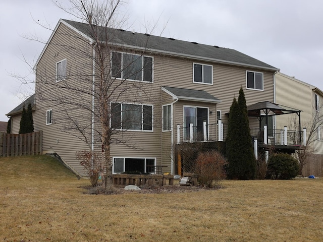 rear view of house featuring a yard