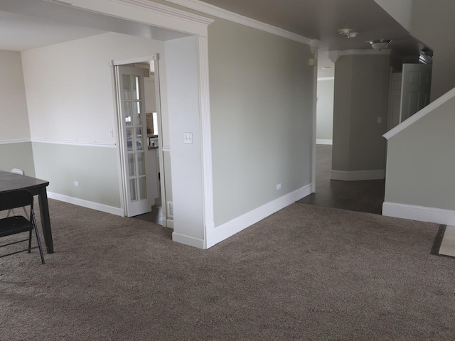 unfurnished room featuring crown molding and dark carpet