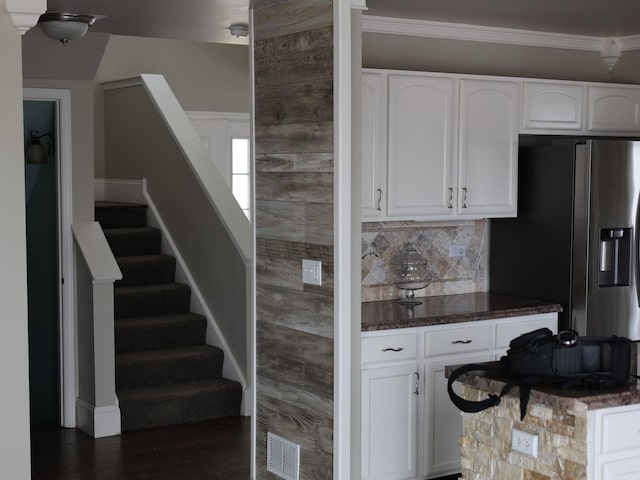 kitchen featuring white cabinetry, decorative backsplash, and stainless steel fridge with ice dispenser