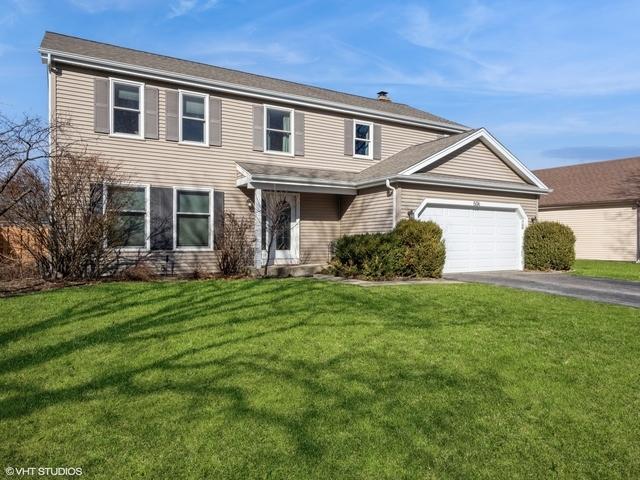 view of front facade with a garage and a front lawn