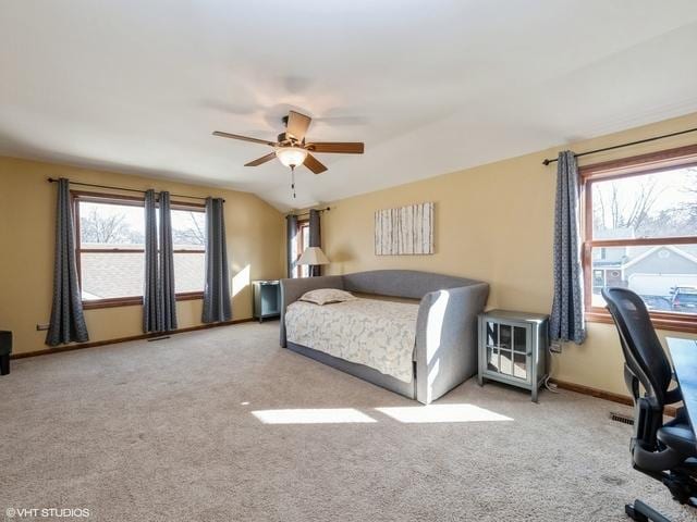 bedroom featuring ceiling fan, light colored carpet, and lofted ceiling