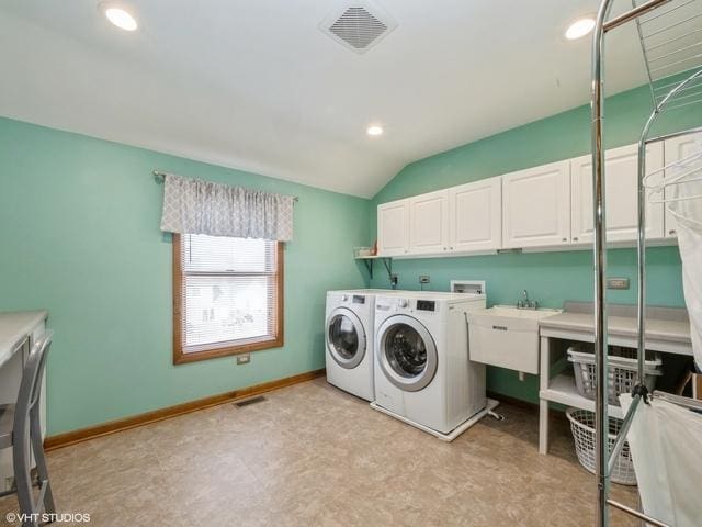 laundry area featuring independent washer and dryer, cabinets, and sink