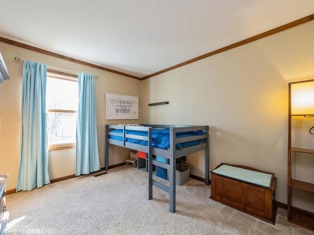 carpeted bedroom featuring ornamental molding