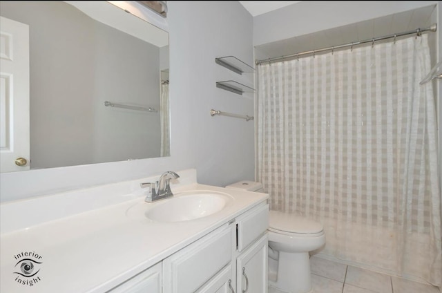 bathroom with vanity, tile patterned floors, and toilet