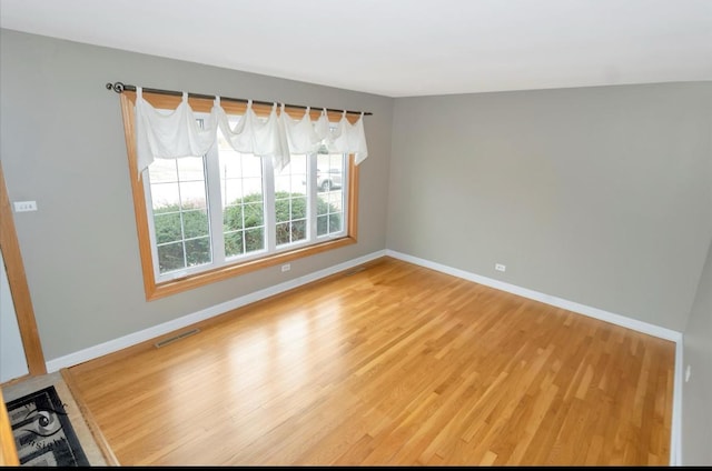 unfurnished room featuring hardwood / wood-style flooring