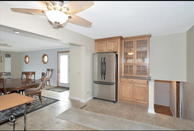 kitchen featuring light tile patterned flooring, ceiling fan, and stainless steel fridge