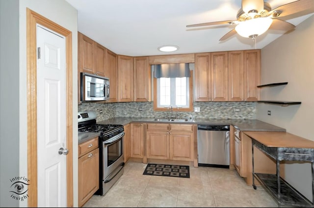 kitchen featuring sink, light tile patterned floors, ceiling fan, stainless steel appliances, and backsplash