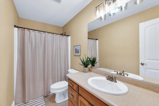 bathroom featuring tile patterned flooring, toilet, vanity, and visible vents