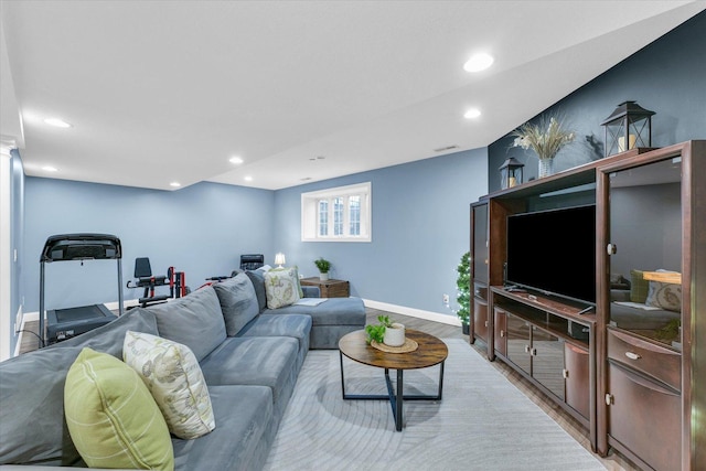 living room with recessed lighting, baseboards, and light wood-style floors