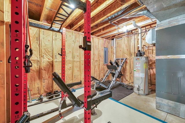 exercise room with electric panel, heating unit, and gas water heater