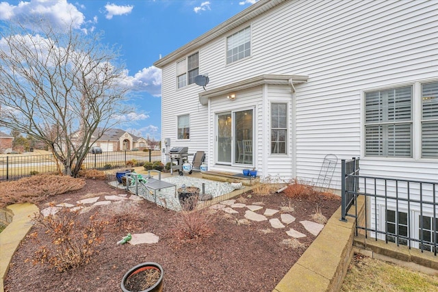 back of property featuring a patio area and fence