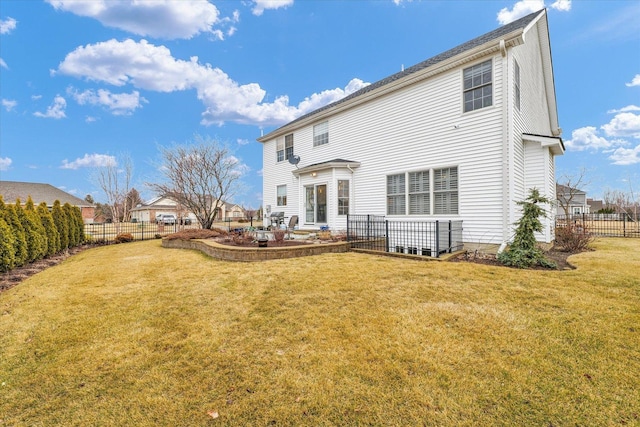 back of house with a patio, a lawn, and a fenced backyard