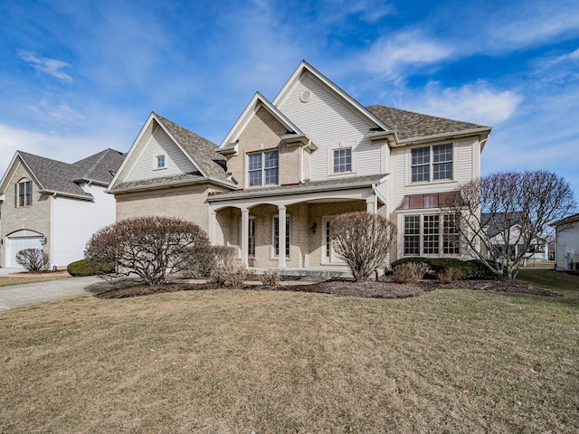 view of front of property featuring covered porch and a front lawn