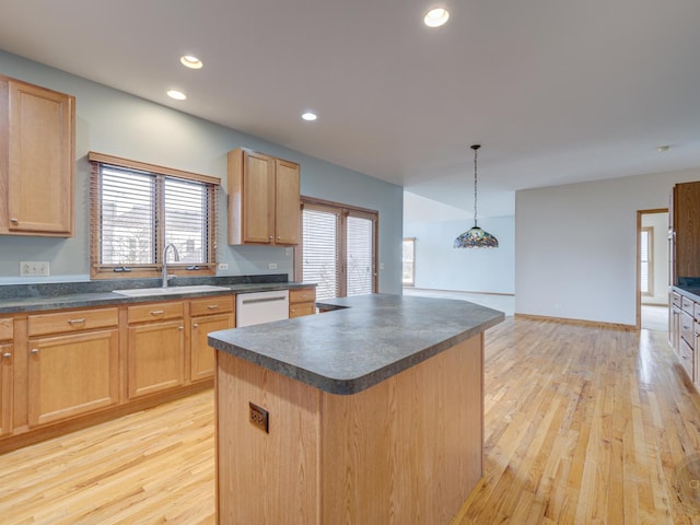 kitchen featuring white dishwasher, a center island, sink, and light hardwood / wood-style flooring