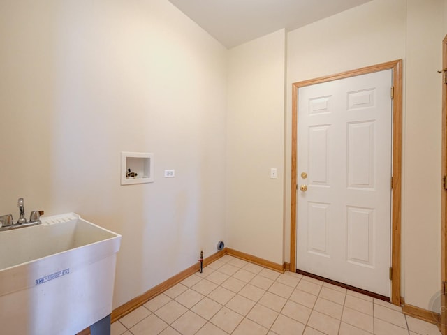 clothes washing area with washer hookup, sink, and light tile patterned floors